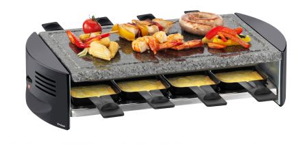 Raclette oven and meal arranged on a dining table